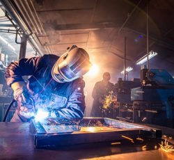 The,two,handymen,performing,welding,and,grinding,at,their,workplace